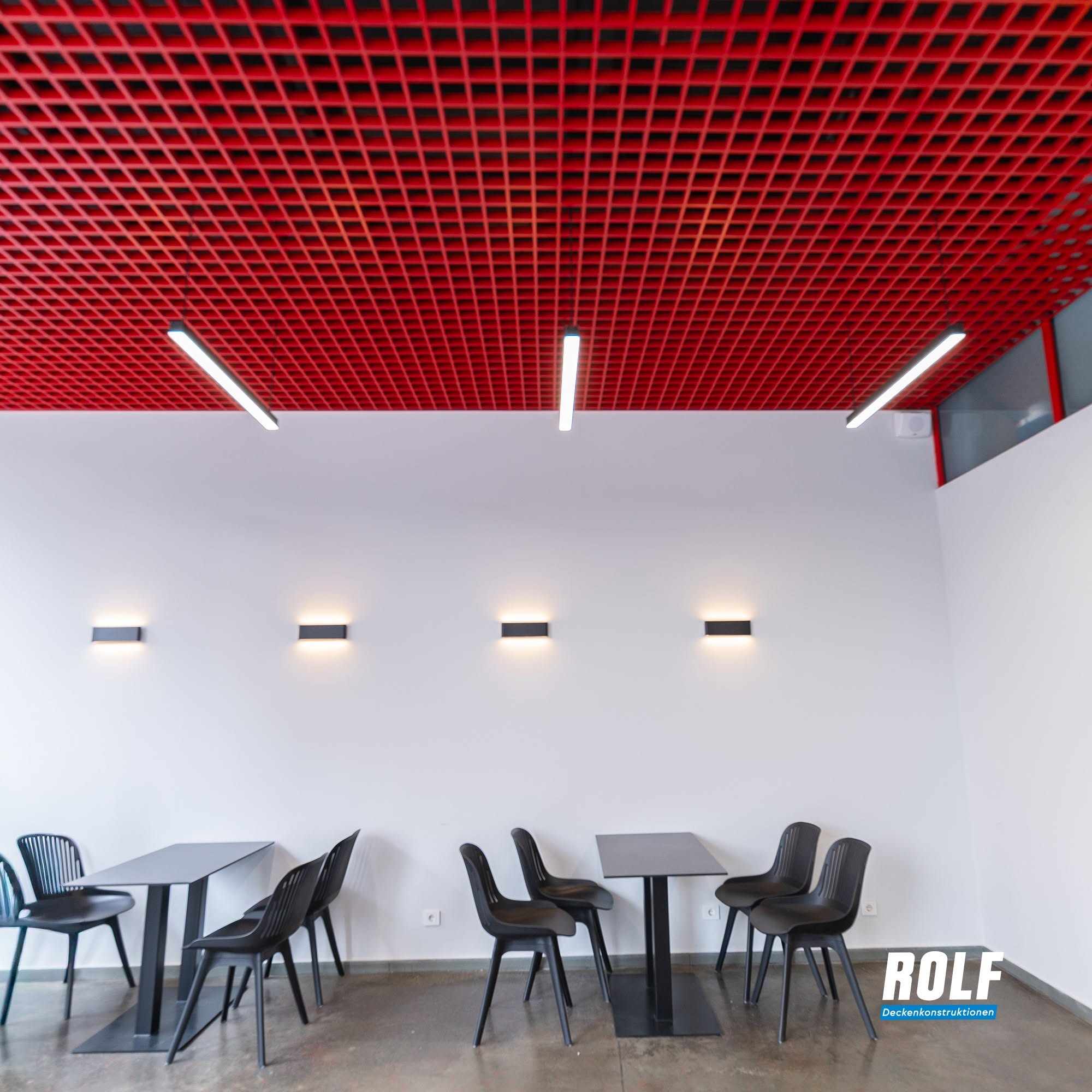 Red grid ceiling with modern lighting